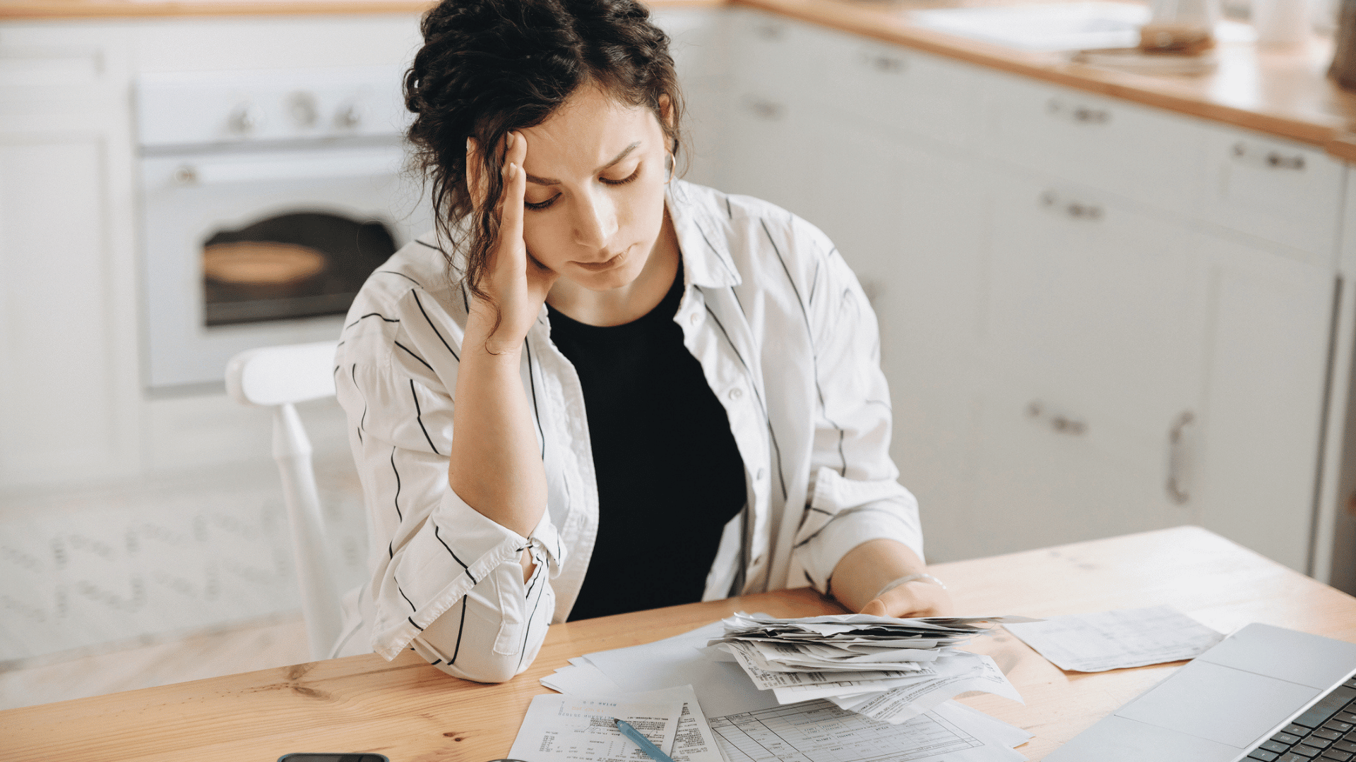 Debt-Movement-woman-with-head-in-hands-paying-bills-worried-iStock-1546311247-credit-Serhii Sheremet.compressed